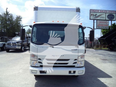 Isuzu NPR-HD box truck front view in dealership lot with TLC truck banner in background.