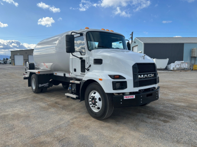 Mack MD7 truck in white fuel tanker body view showing front grille with MACK badge and side step, fuel tank behind cab, orange clearance lights on cab roof.