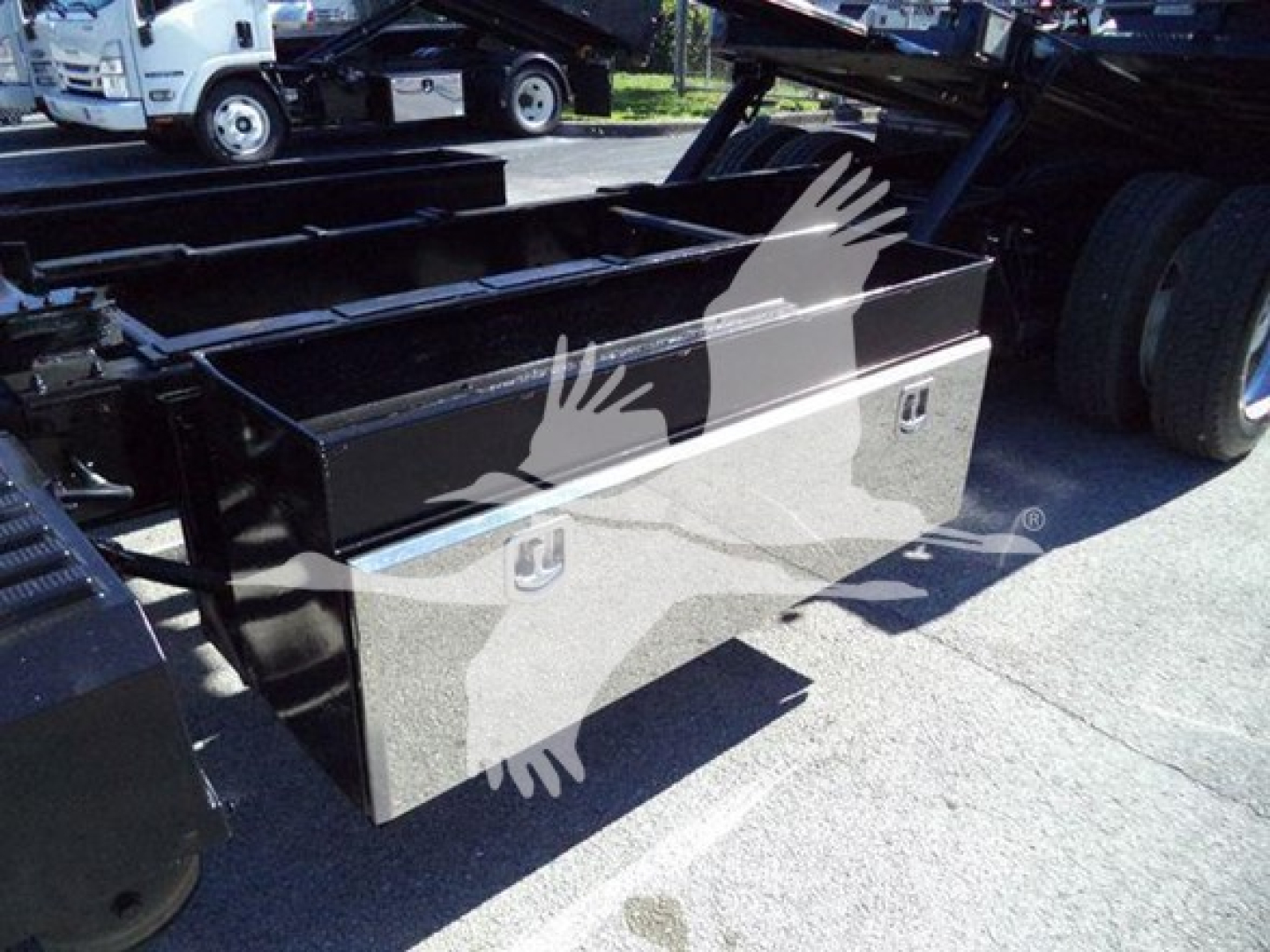 Truck toolbox mounting on a rollback truck, metal storage box with handles and latches, part of a 2022 International MV listed for sale.