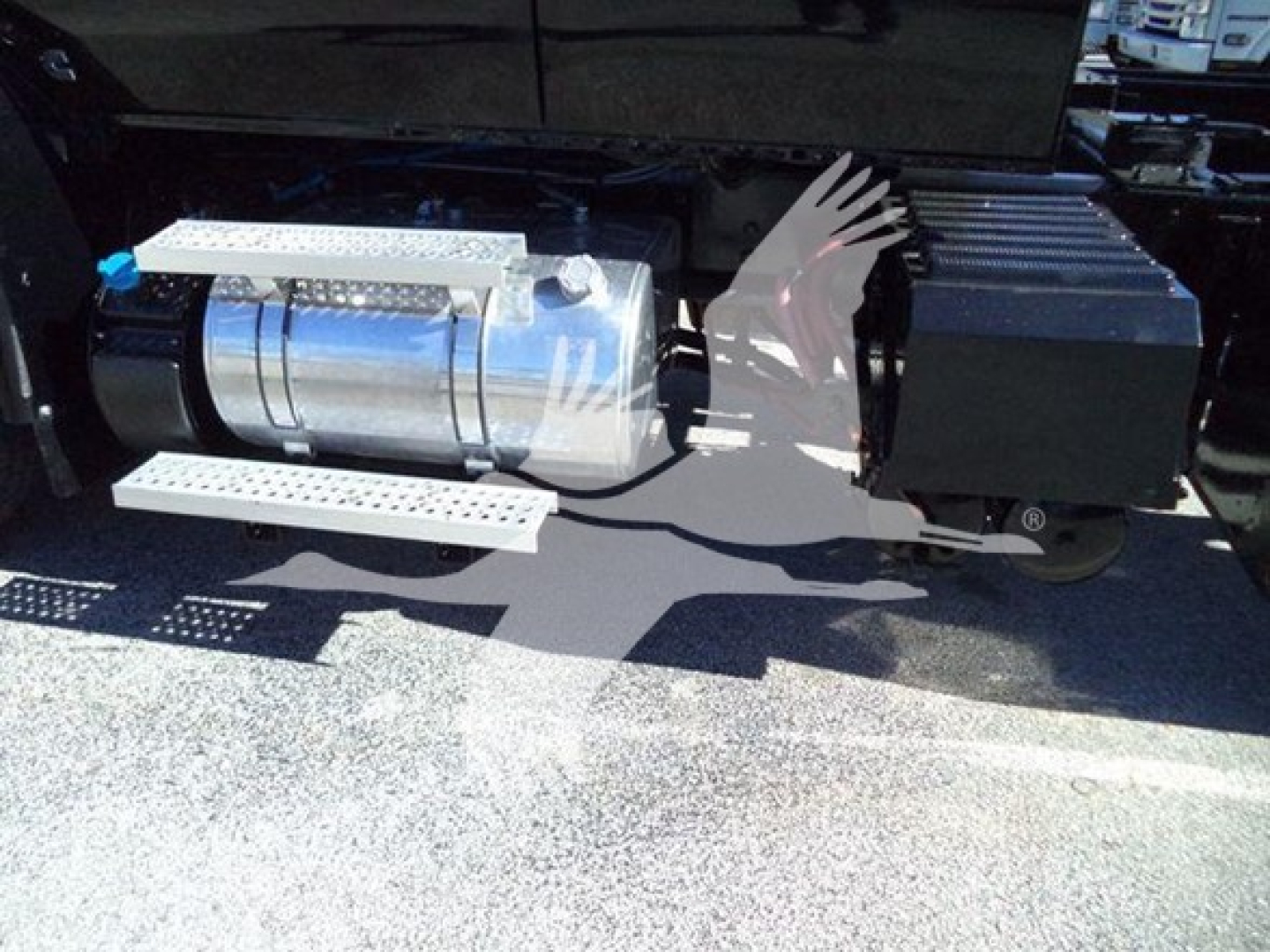 Truck side fuel tank and toolbox with steps visible on a 2022 International MV rollback truck.