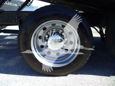 Wheel assembly and hub of a 2022 International MV rollback truck showing polished steel rim and tire.