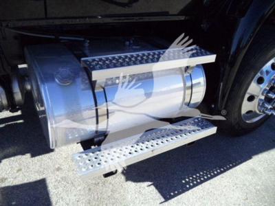 International MV truck side view showing polished metal fuel or storage tanks with perforated steps and chrome running board