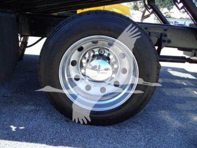 Truck wheel and undercarriage with a front chrome hubcap visible.