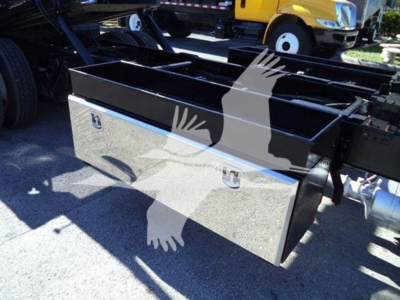 Flatbed toolbox mounted on a truck chassis showing a chrome aluminum toolbox with two latches and a blue accent, part of a rollback truck setup.