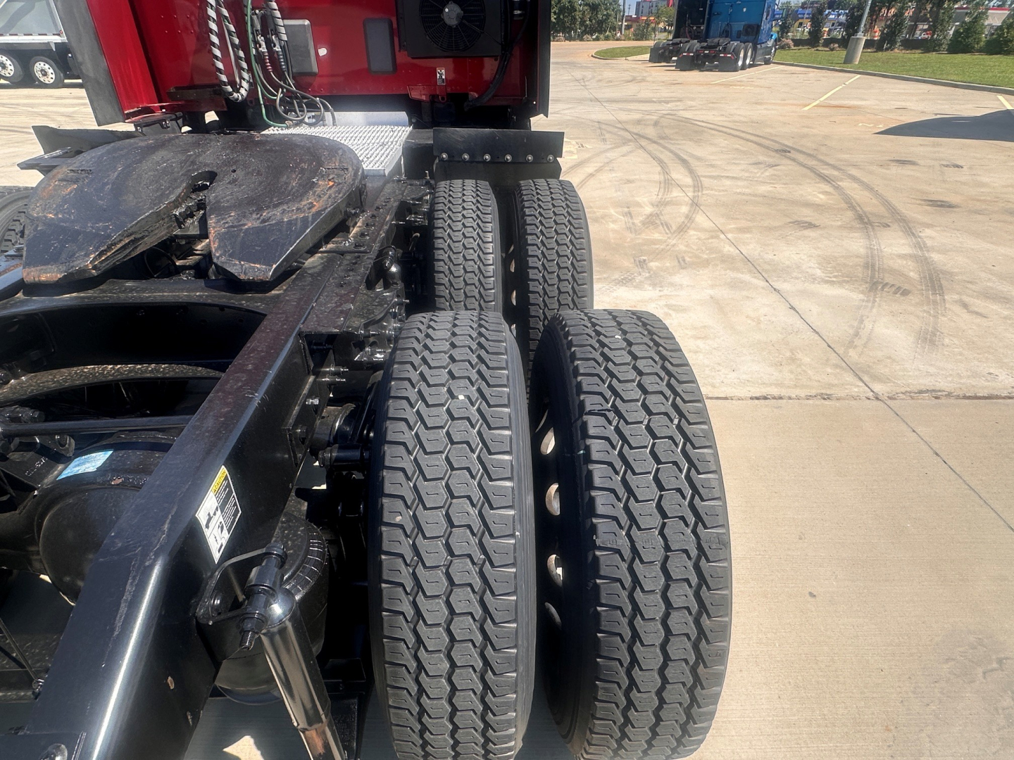 Peterbilt 579 truck chassis rear view showing dual rear axles and dual tires with tread pattern.