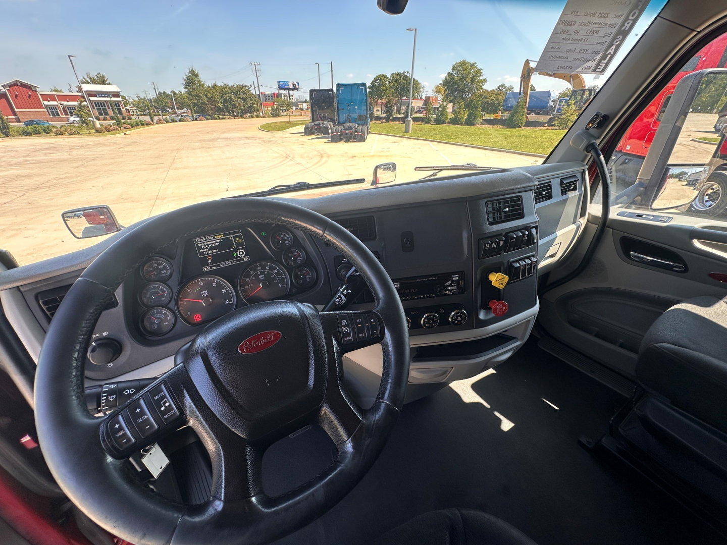 Peterbilt 579 cab interior showing steering wheel, dashboard gauges, and center console.