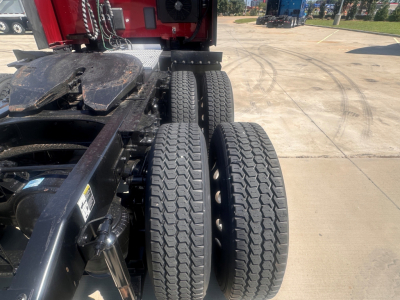 Peterbilt 579 truck chassis rear view showing dual rear axles and dual tires with tread pattern.
