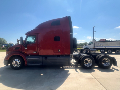 Peterbilt 579 conventional sleeper truck side profile with red cab and chassis; side window, door handle, fuel tank, and dual rear axles visible.