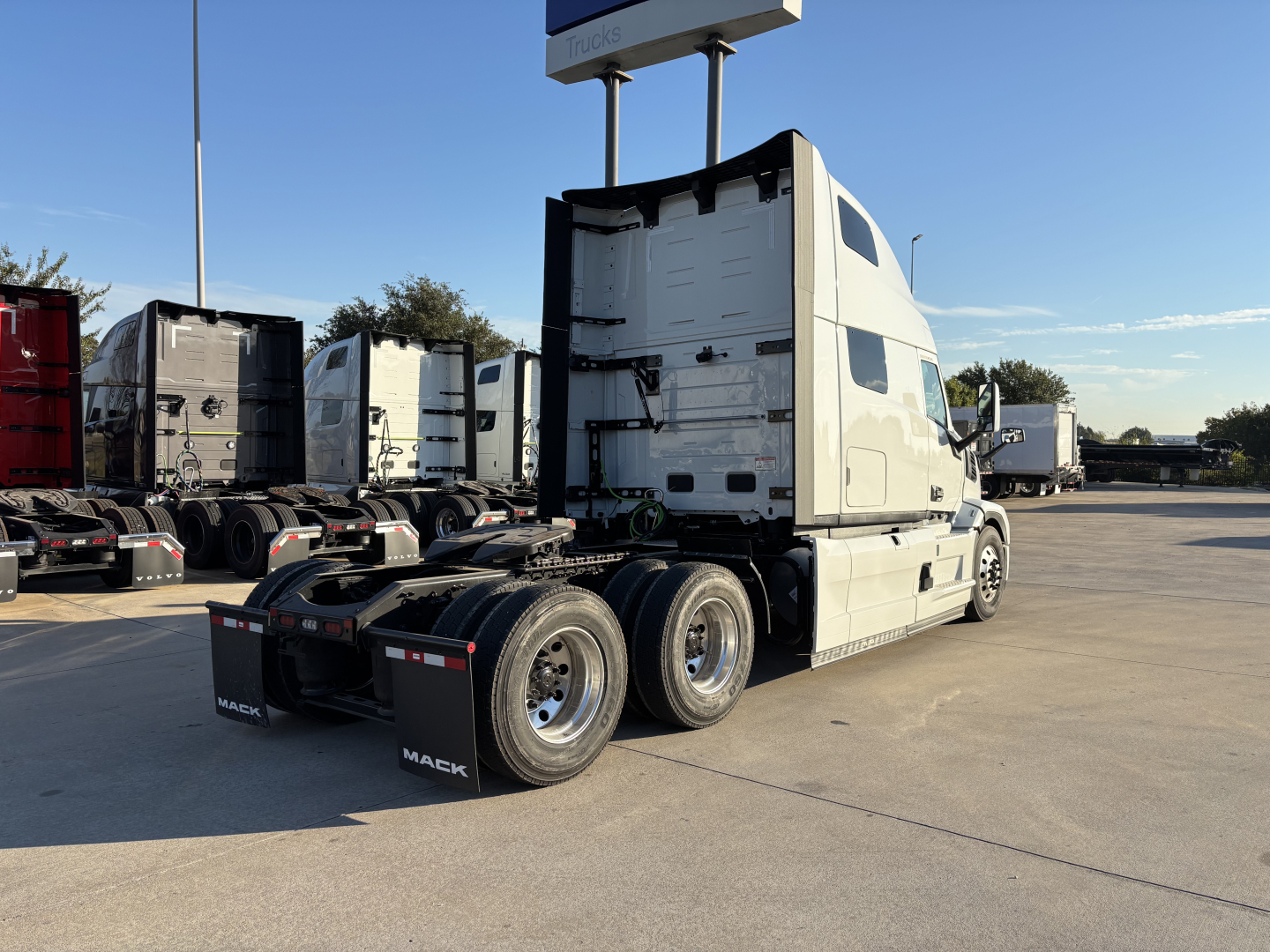 Mack PR64T76H conventional sleeper semi-truck tractor in white, rear view showing day cab with multiple axles and dual rear wheels, VIN visible in listing.