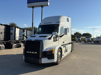 Mack PR64T76H truck in a dealership lot with cab over engine and sleeper exterior visible.