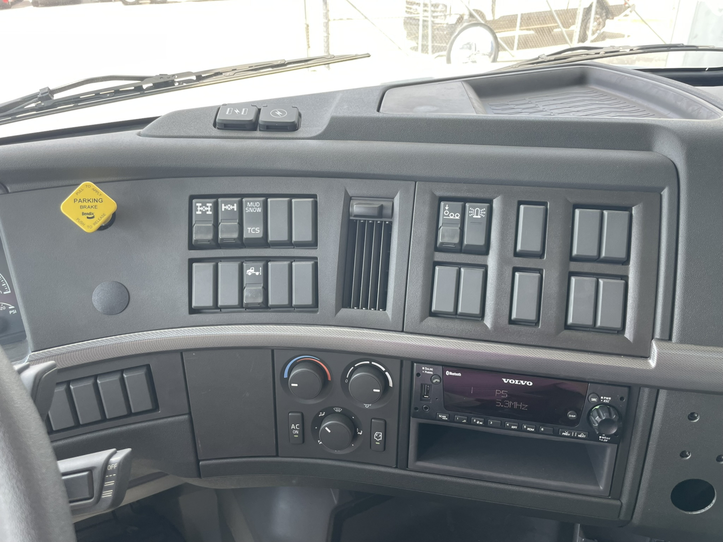 Volvo VHD86B300 truck dashboard/instrument panel showing multiple switches and climate controls.