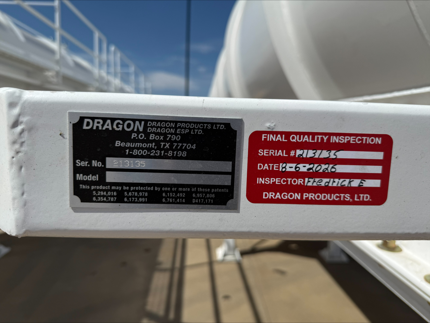 Trailer frame label: DRAGON brand plate with model/serial numbers and a red final quality inspection sticker. Visible text includes DRAGON PRODUCTS LTD, P.O. Box 790, Beaufort, etc., and a serial number field.