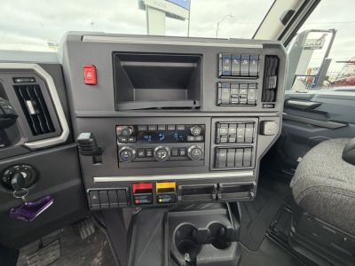 Truck cab dashboard showing controls, vents, and switches in a Mack AN64T truck interior.