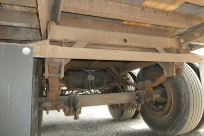 Trailer underside showing suspension, axle, and wheels of a 2006 Great Dane 7411T-SSL trailer with rust-toned frame and dual wheels.
