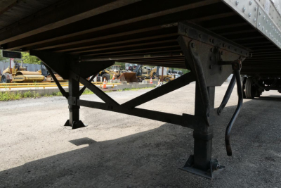 Great Dane trailer undercarriage showing steel support legs and cross-bracing.