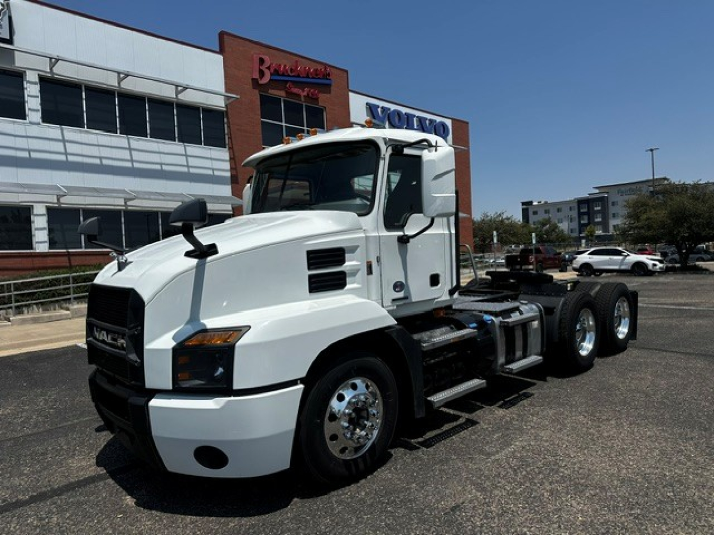 Truck: 2021 Mack Anthem conventional daycab with white exterior, cab mirrors, dual rear axles, and fuel/tank area visible.
