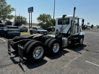 Truck chassis and cab of a 2021 Mack Anthem seen from side rear, showing dual rear axles, fifth-wheel area, and exhaust stack.