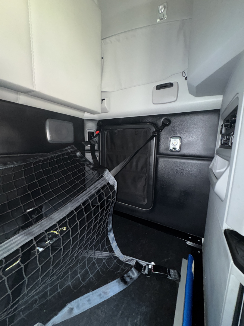 Kenworth T680 cab interior showing side dash area and storage pocket with text not visible.
