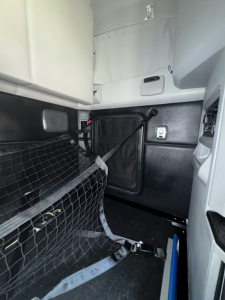 Kenworth T680 cab interior showing side dash area and storage pocket with text not visible.