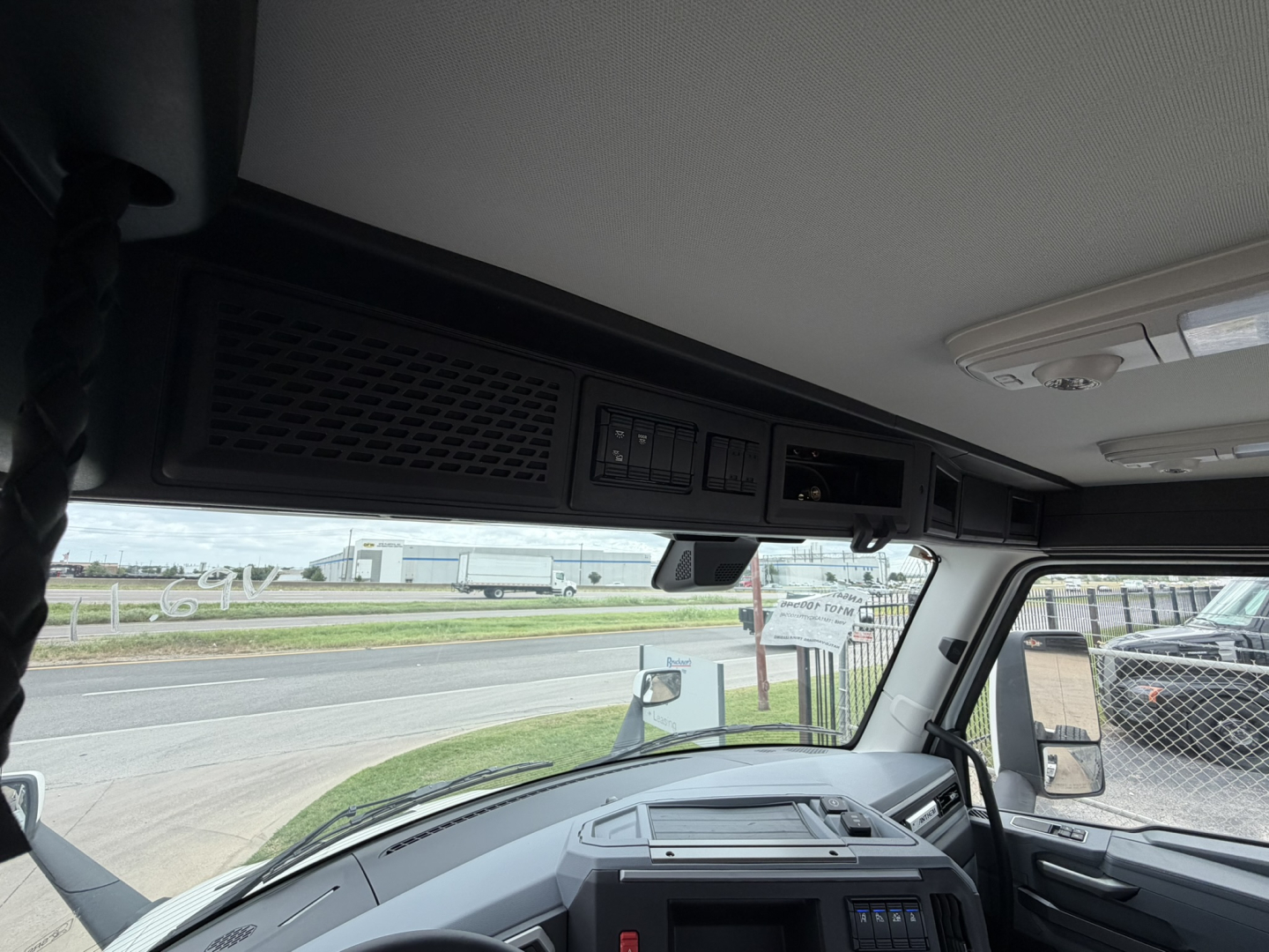 Interior of 2026 Mack AN64T daycab truck cabin showing overhead control console and dashboard area.