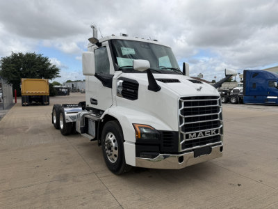 White 2026 Mack AN64T conventional daycab truck front-left view showing chrome grille, bumper, and dual rear axles; VIN 1M1A24GY7TM100546