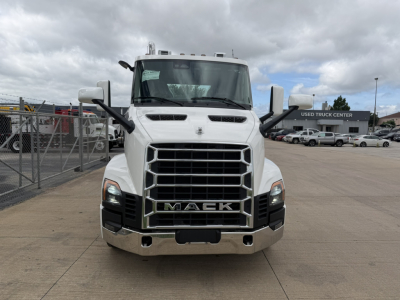 Front view of a white Mack AN64T truck showing large grille with MACK emblem, headlights, chrome bumper.