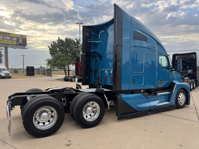 Kenworth T680 tractor in blue profile view showing sleeper cab and dual rear axles.