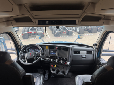Kenworth T680 truck cab interior dashboard view with steering wheel, instrument cluster, center console, and dashboard controls.