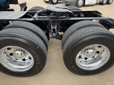 Kenworth T680 truck rear dual axle wheels and suspension with polished chrome rims.