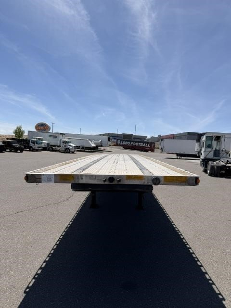 Flatbed trailer top view showing Utility air ride combo flatbed with reflective tape along edges and side-mounted lighting.