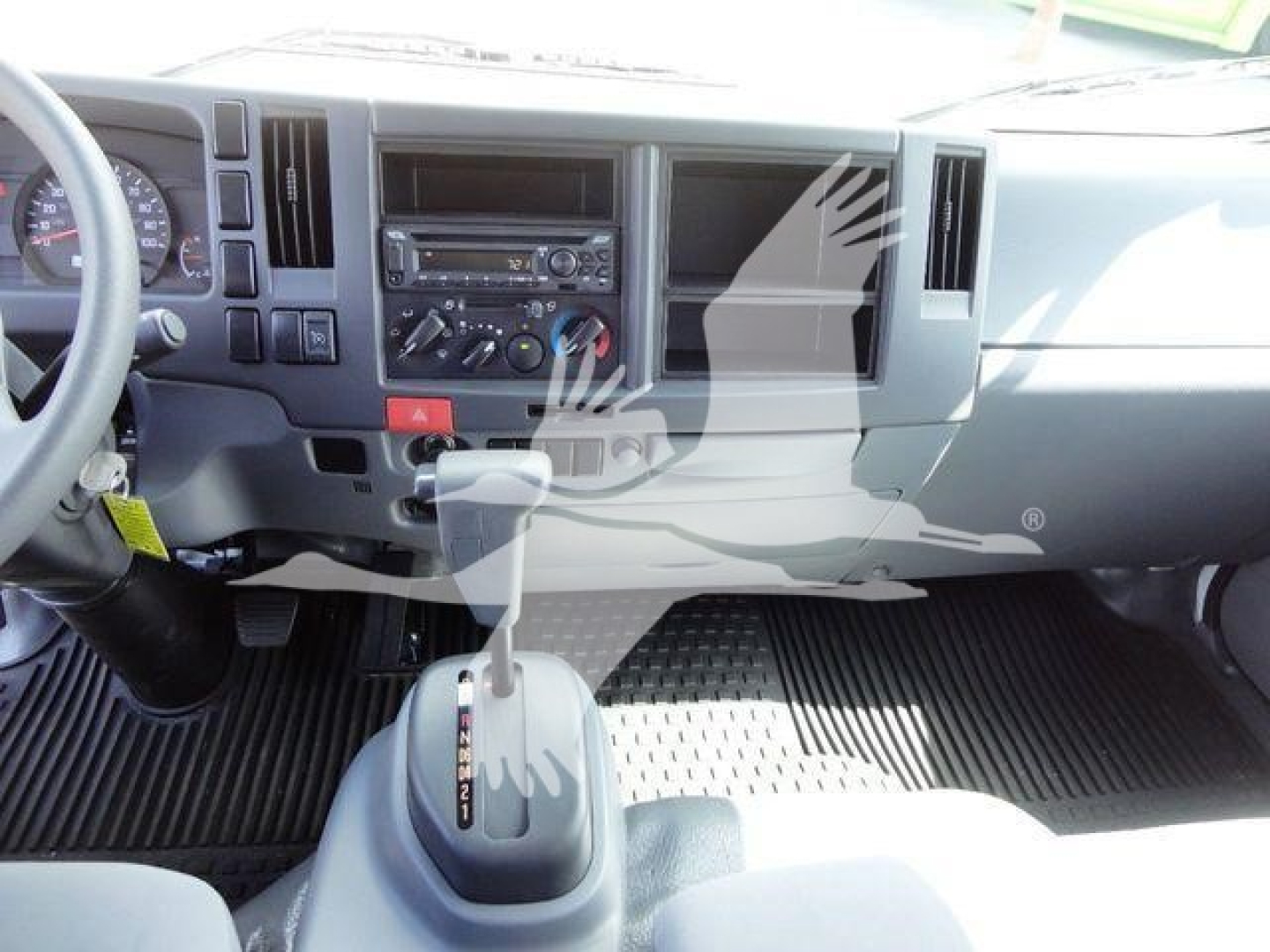 Isuzu NPR-HD truck interior showing gear shifter and dashboard controls