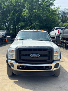 Ford F-550 front view showing grille with Ford emblem, 'SUPER DUTY' badge on hood, black grille, bumper, headlights, and amber clearance lights on roof.