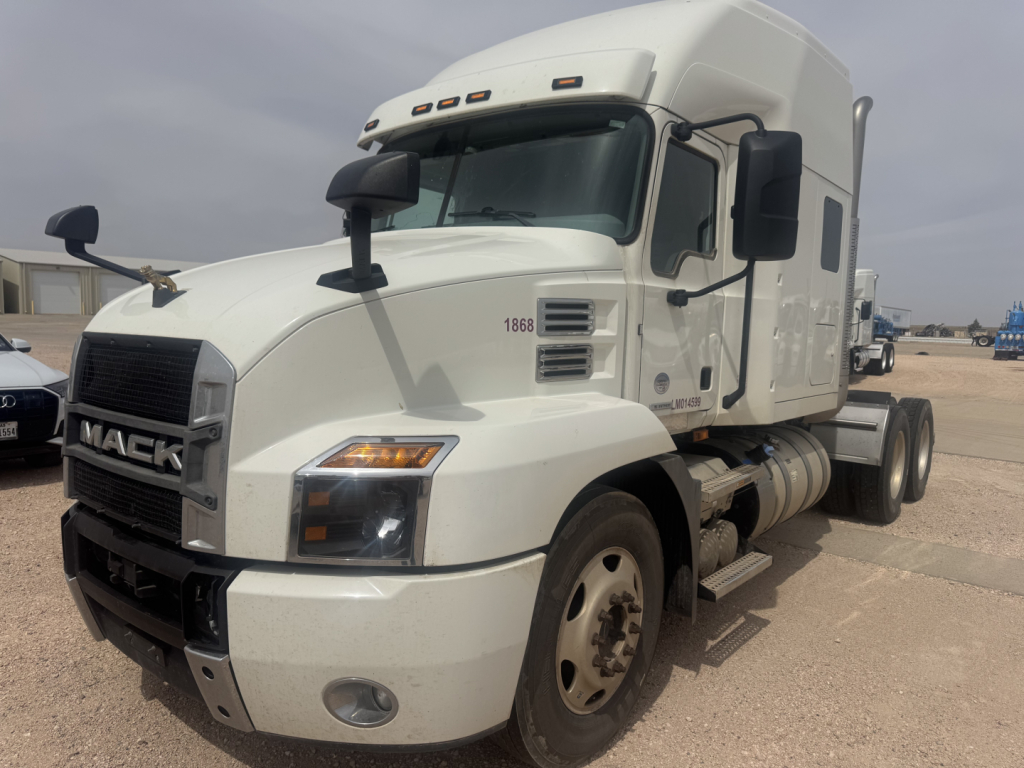 Mack ANTHEM truck cab and sleeper in white, front-left view, showing grille with MACK badge, headlights, side mirrors, and dual rear wheels.