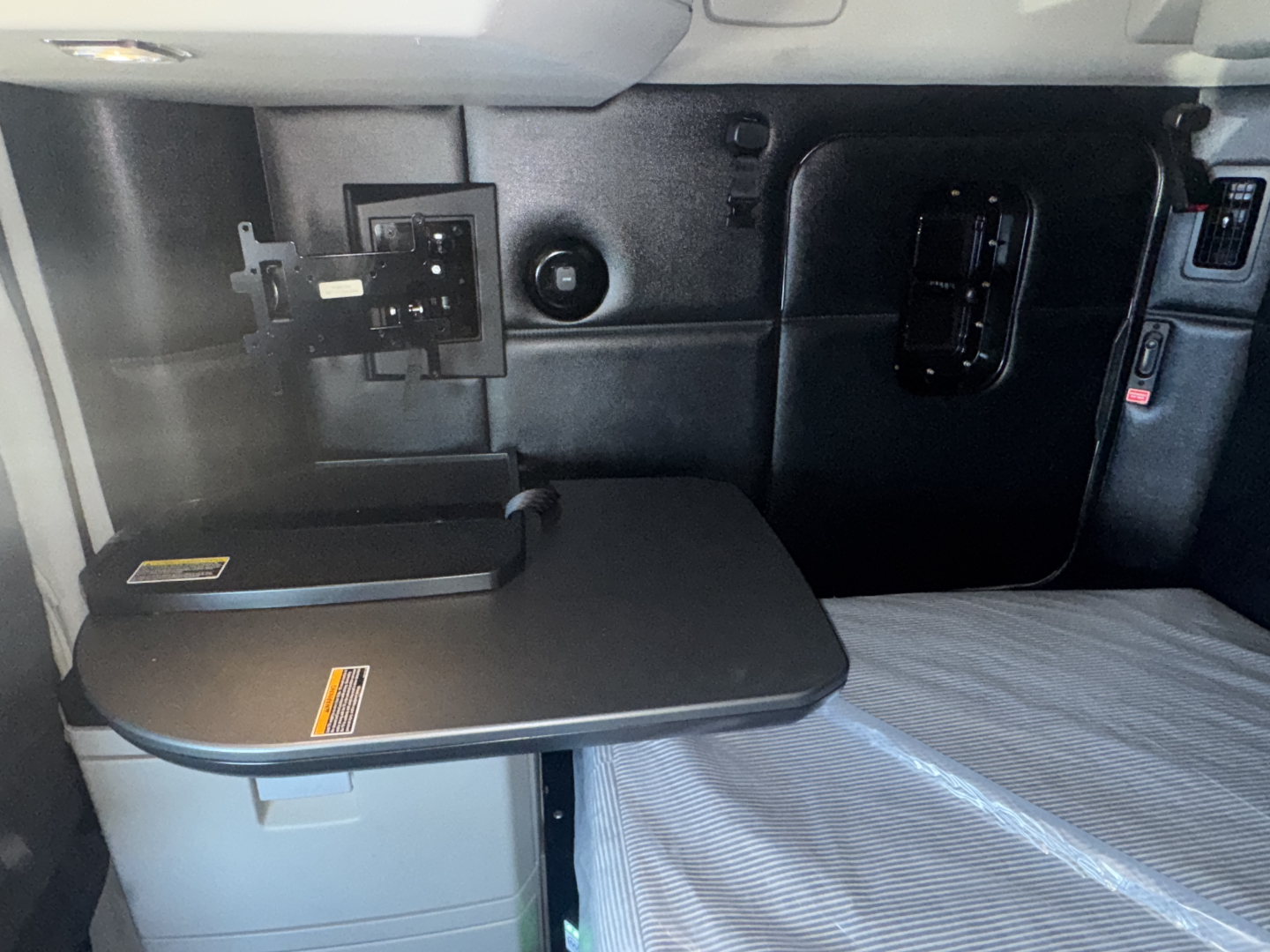Kenworth T680 sleeper cab interior with fold-out table and control panel visible.