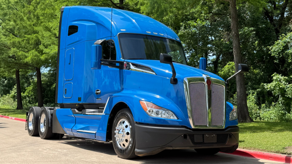 Kenworth T680 truck in blue, front-right view showing cab, grille, and chrome accents.