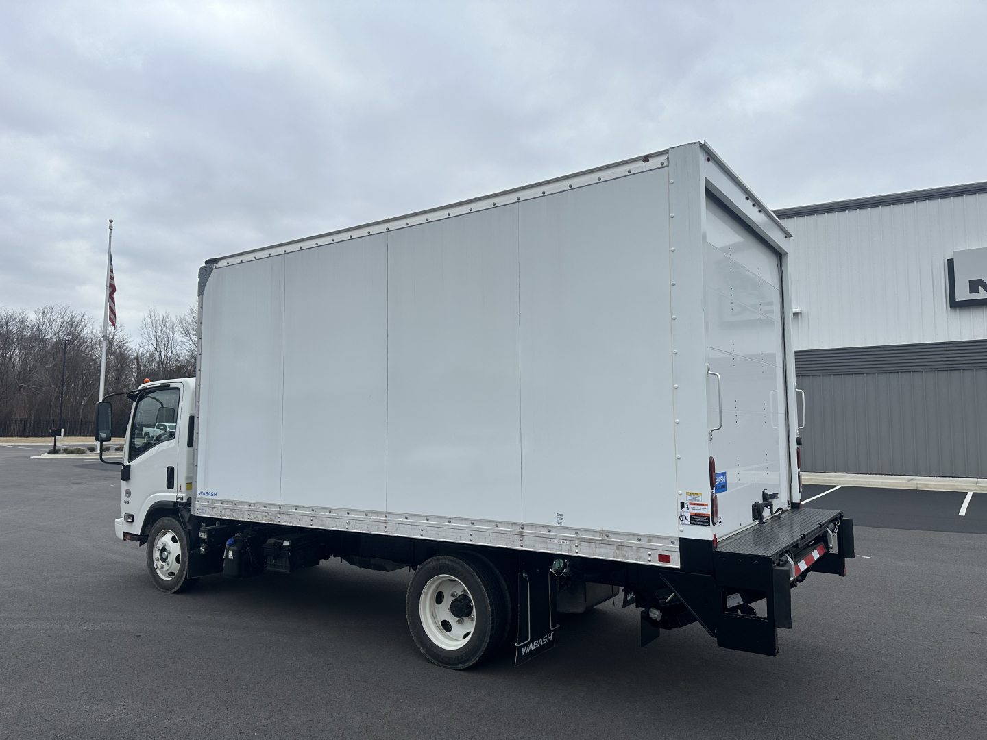 Box truck 2024 Hino S5 side/rear view showing cargo area and rear underride bumper.
