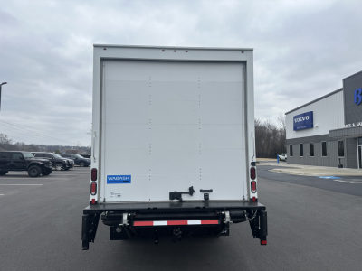 Rear view of a 2024 Hino S5 box truck showing cab and cargo area, with WBASH brand sticker on the rear door and taillight assembly.