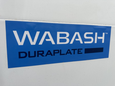 WABASH DURAplate blue logo sticker on white truck side wall.