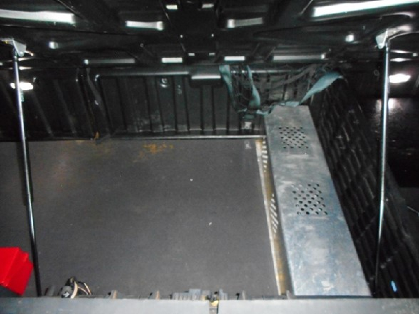 Trunk/cab interior of a 2023 Freightliner Cascadia 126 sleeper showing metal floor panel and equipment rack.