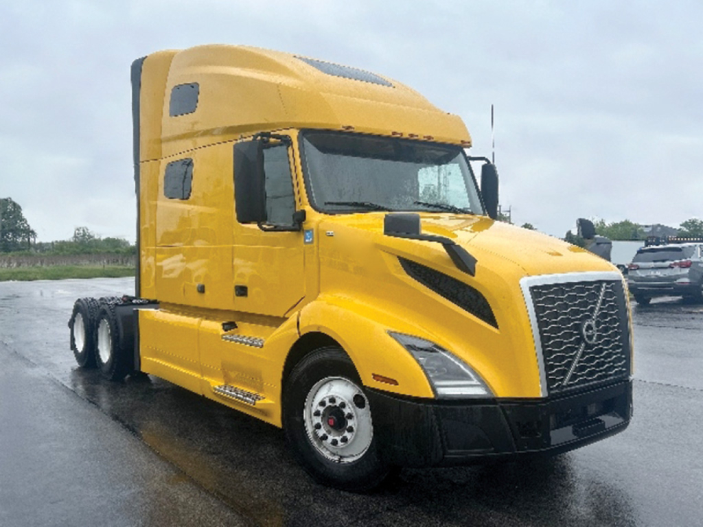 Volvo VNL 760 sleeper cab tractor showing front grille and yellow body with black accents.