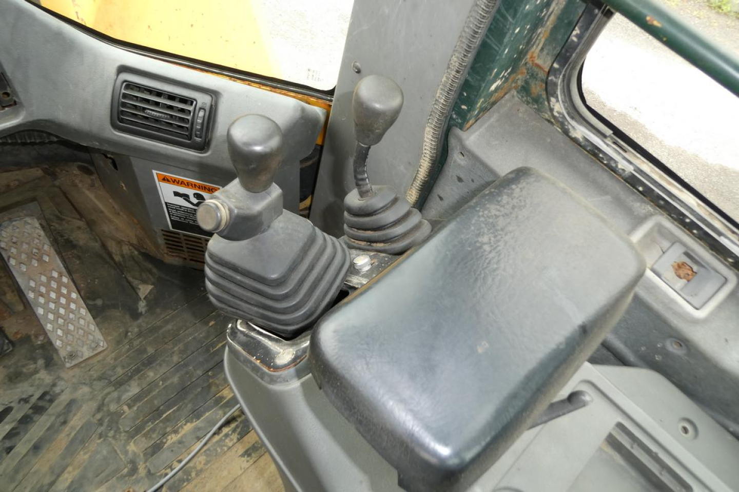 Kawasaki 65TMV wheel loader interior showing two joystick controls and foot pedals.