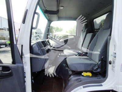 Isuzu NPR HD cab interior with steering wheel, dashboard, and front seats visible; no visible labels or text legible other than general cabin features.