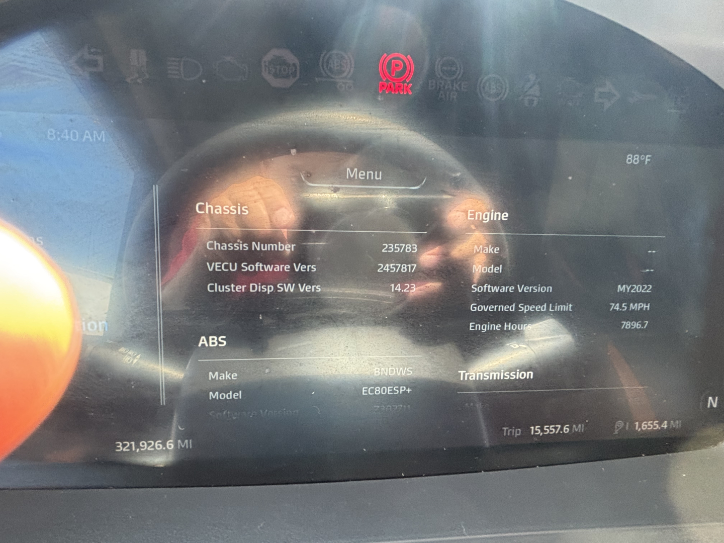 Kenworth T680 dash display showing vehicle data including chassis number, software versions, engine hours, and trip info.