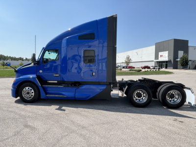 Kenworth T680 sleeper cab tractor in blue, side view, with dual rear axles and black accents.