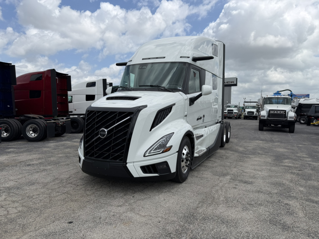 Front view of a white Volvo VNL64T860 semi-truck tractor in a lot, showing the distinctive black grille and Volvo emblem.