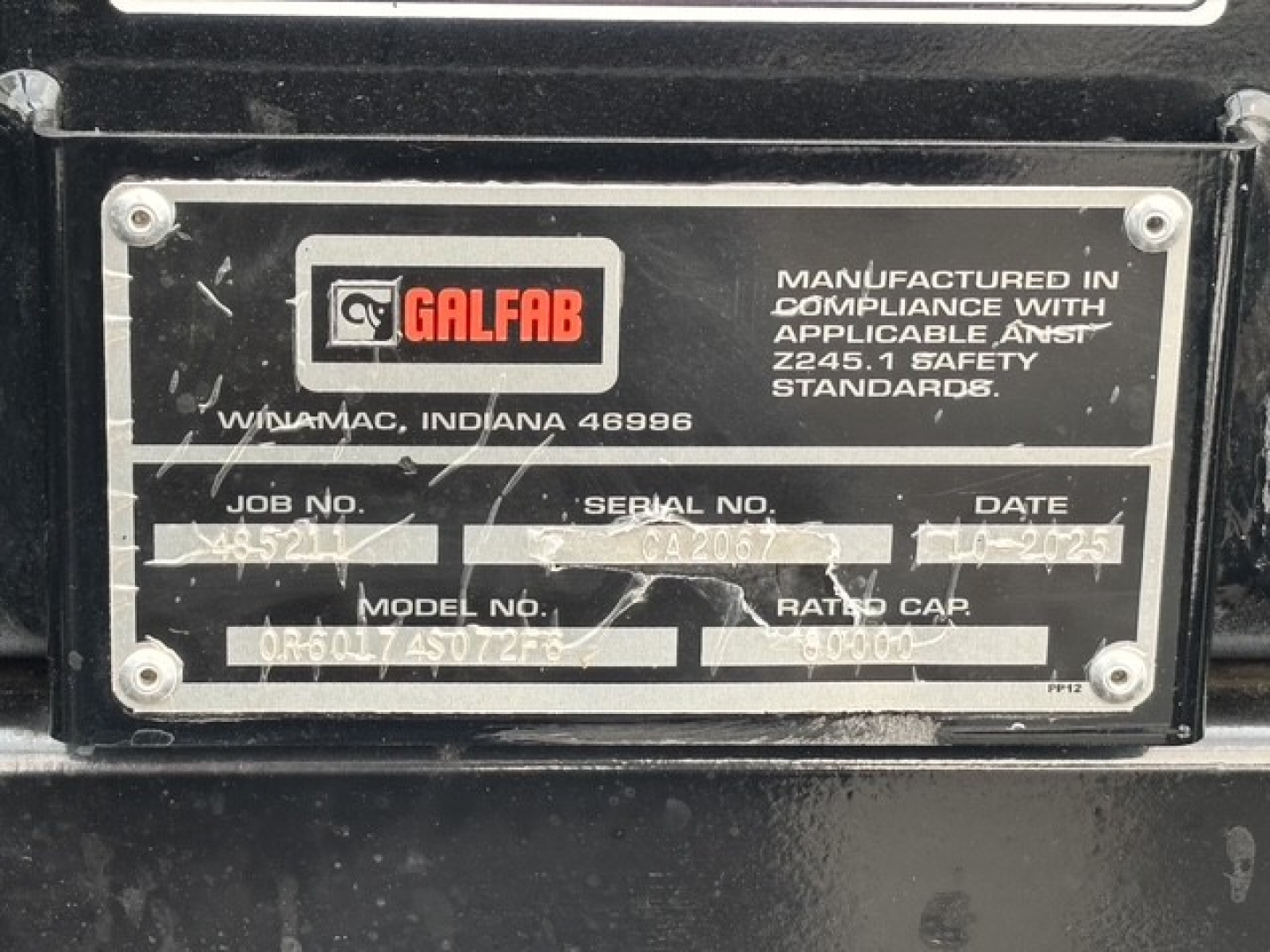 Label plate on equipment showing Galfab logo, manufactured in compliance with standards, serial and job numbers, model and date fields, Windemac Indiana location.