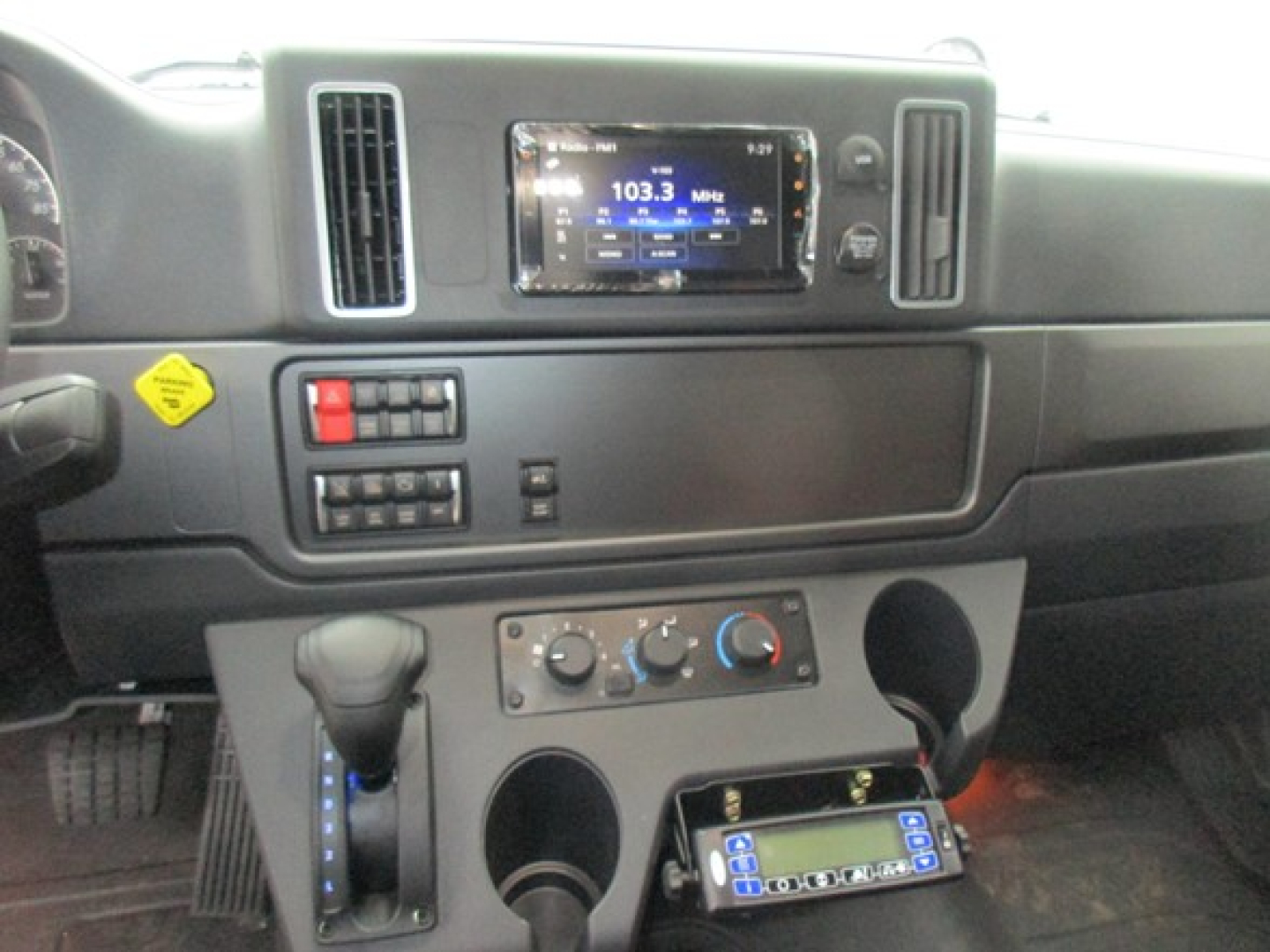 Freightliner M2 106 Plus dashboard showing digital radio display and controls