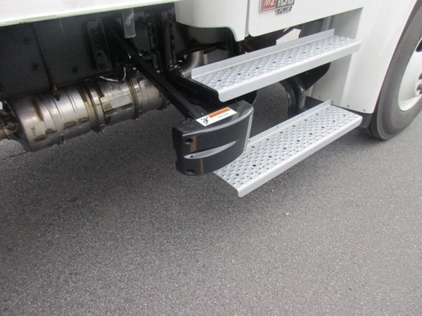 Freightliner M2 106 Plus side steps and rear engine area visible