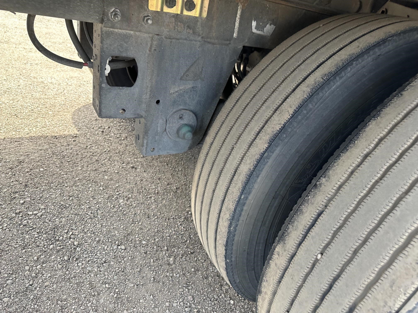 Trailer wheel and suspension area of a 2022 Utility 3000R reefer trailer showing dual tires and undercarriage components.