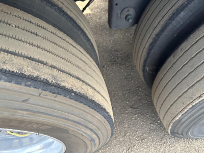 Trailer tires and undercarriage of a 2022 Utility 3000R reefer trailer showing dual tires and wheel treads.